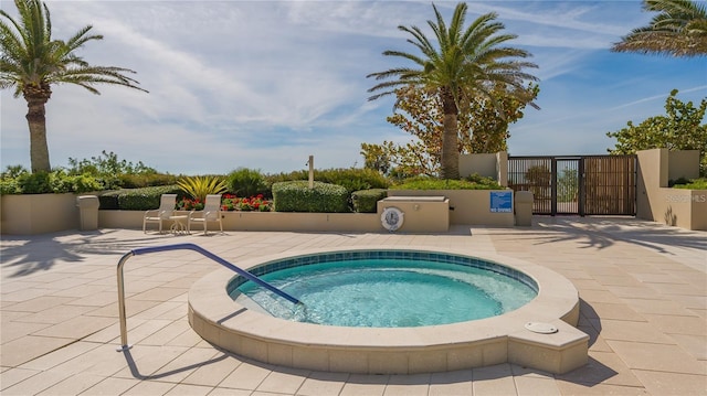 view of pool with a community hot tub and a patio