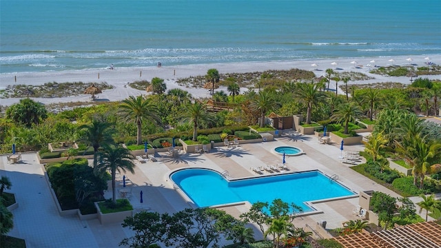 bird's eye view featuring a water view and a beach view