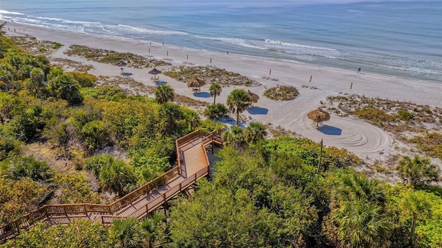 drone / aerial view with a water view and a beach view