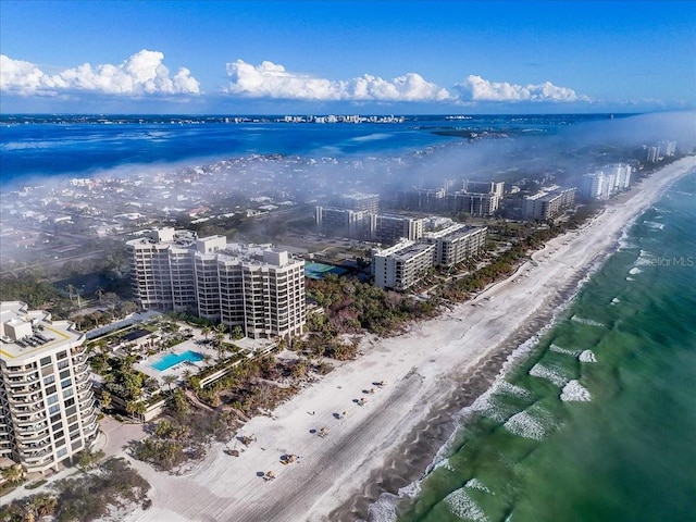 bird's eye view featuring a water view and a beach view