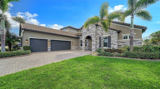 mediterranean / spanish home featuring a front yard