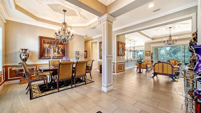 dining area featuring an inviting chandelier, a raised ceiling, crown molding, and decorative columns