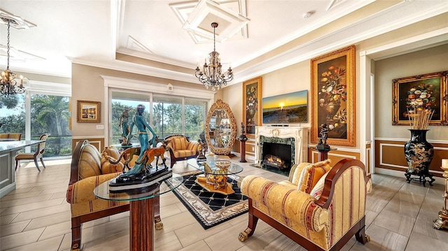 living room with a fireplace, a tray ceiling, and crown molding