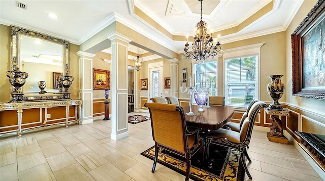 dining space with ornate columns, ornamental molding, a raised ceiling, a notable chandelier, and light tile patterned flooring