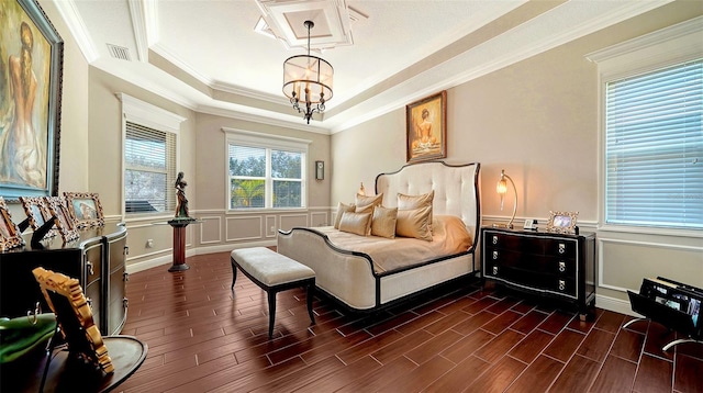 bedroom featuring a tray ceiling, multiple windows, crown molding, and a notable chandelier