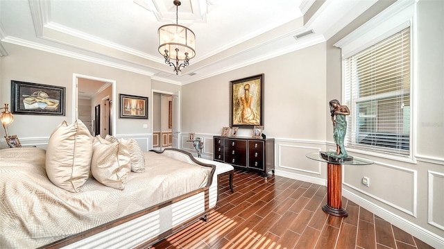 bedroom featuring a tray ceiling, a chandelier, and ornamental molding