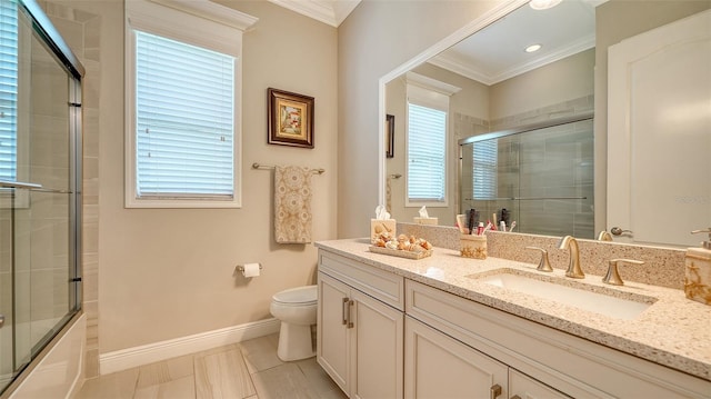 full bathroom with tile patterned floors, crown molding, combined bath / shower with glass door, toilet, and vanity