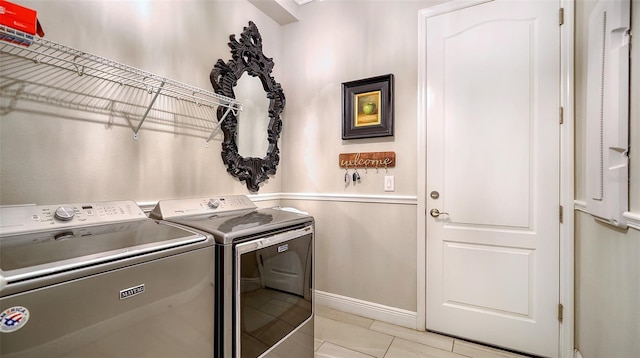 washroom with light tile patterned flooring and independent washer and dryer