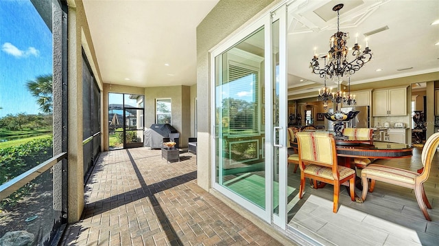 sunroom featuring an inviting chandelier