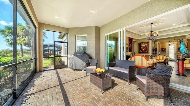 sunroom featuring a notable chandelier