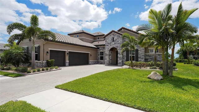 mediterranean / spanish house with a garage and a front yard