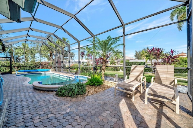 view of pool with glass enclosure, a patio area, and a jacuzzi