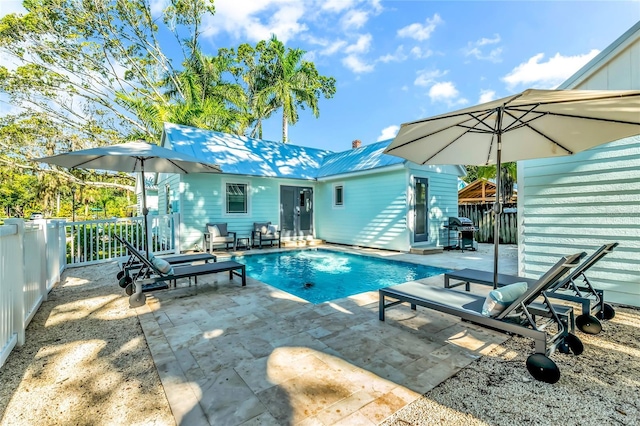 view of pool featuring grilling area and a patio