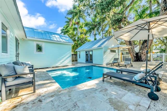 view of swimming pool with a patio and an outdoor structure