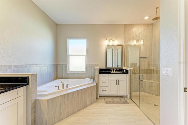 bathroom featuring tile patterned flooring, vanity, and independent shower and bath