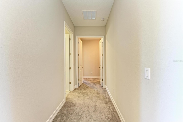 hallway featuring light carpet