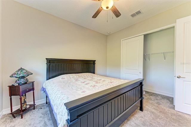 carpeted bedroom featuring ceiling fan and a closet