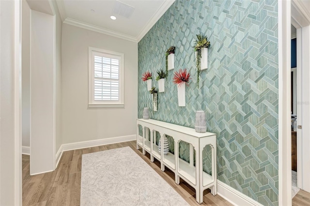 interior space with wood-type flooring and crown molding