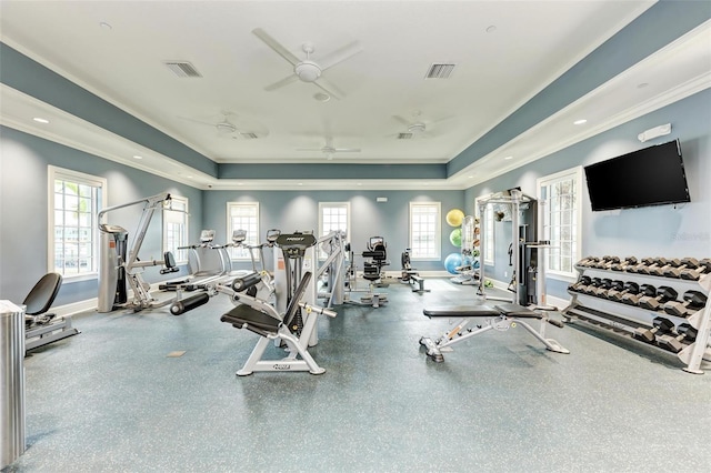 workout area with a raised ceiling and ceiling fan