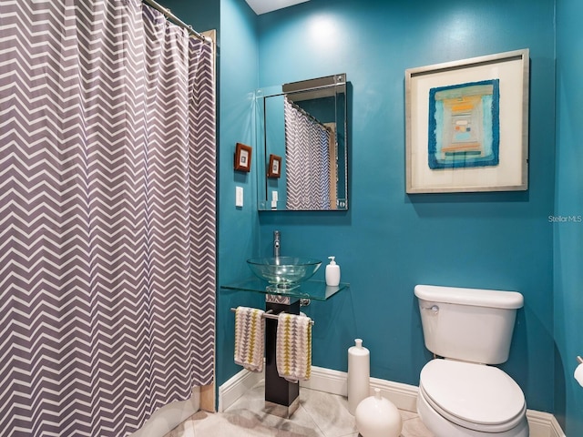 bathroom featuring a shower with curtain, sink, tile patterned flooring, and toilet