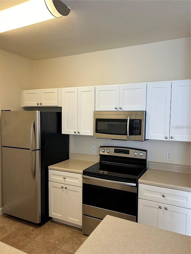 kitchen featuring white cabinetry and appliances with stainless steel finishes