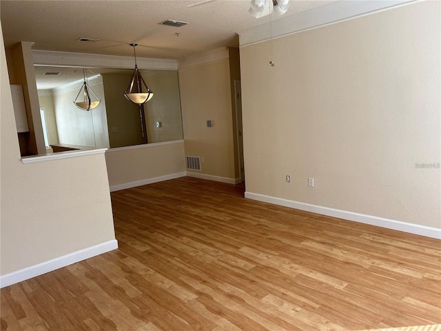 unfurnished room with hardwood / wood-style flooring, ceiling fan, and crown molding