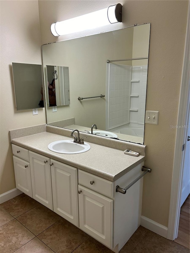 bathroom featuring tile patterned flooring and vanity