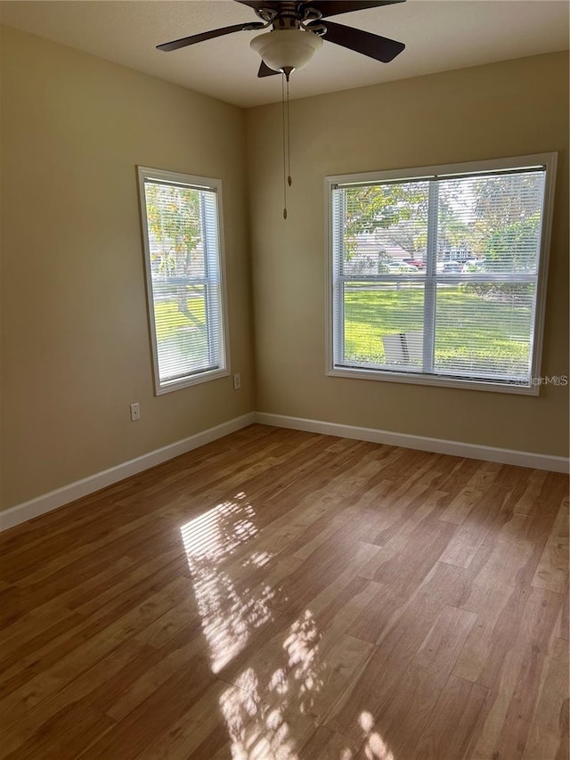 empty room with light hardwood / wood-style floors and ceiling fan