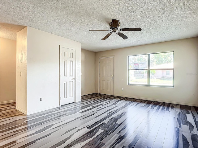 unfurnished bedroom with hardwood / wood-style flooring, ceiling fan, and a textured ceiling