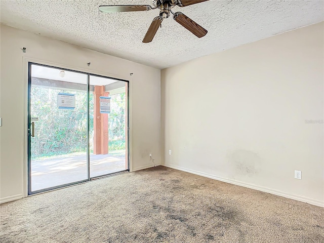 carpeted empty room featuring ceiling fan and a textured ceiling