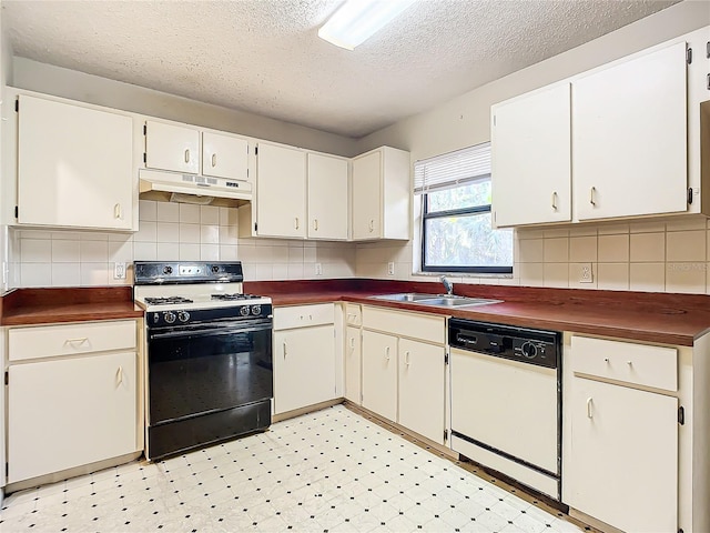 kitchen featuring white dishwasher, black range, white cabinets, and sink