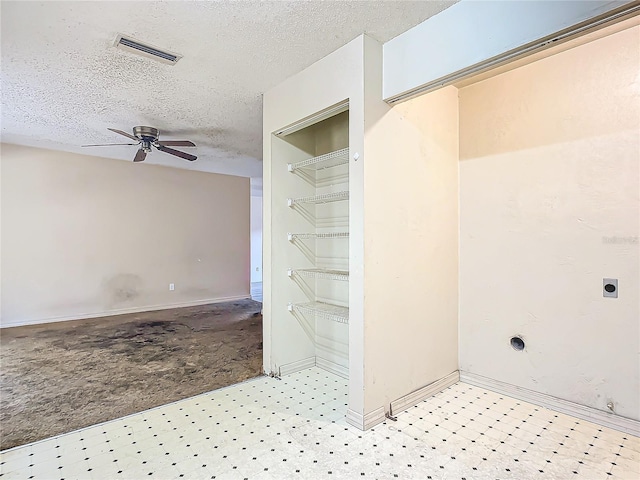 interior space featuring a textured ceiling and ceiling fan