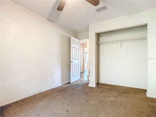 unfurnished bedroom with a textured ceiling, a closet, and ceiling fan