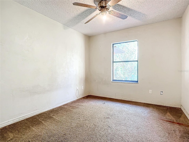 carpeted empty room with ceiling fan and a textured ceiling