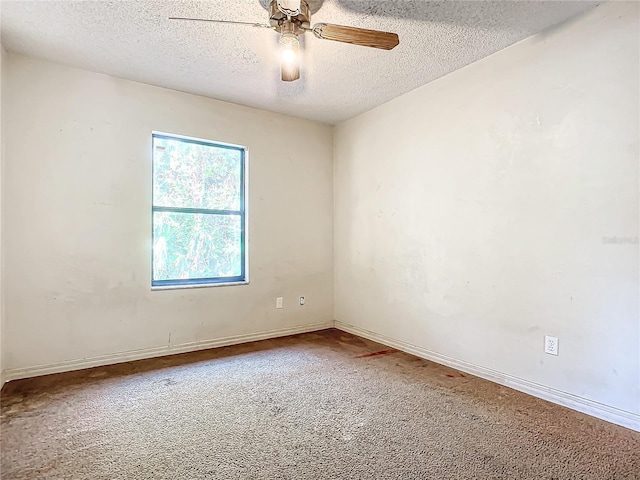 empty room featuring carpet flooring, ceiling fan, and a textured ceiling