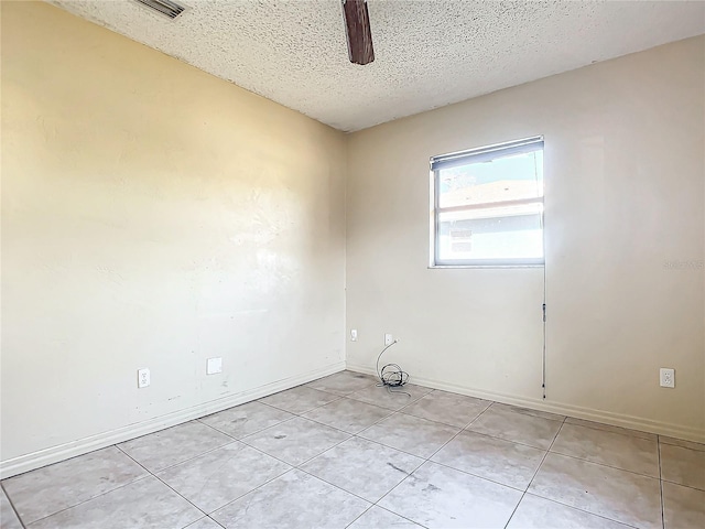 unfurnished room with light tile patterned floors, a textured ceiling, and ceiling fan