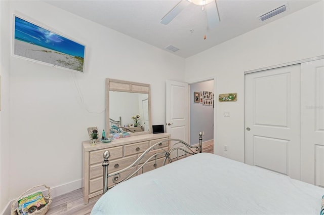 bedroom with ceiling fan, light hardwood / wood-style flooring, and a closet