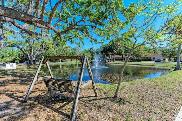 view of playground with a water view