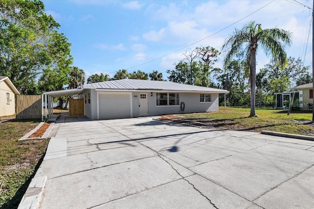 single story home featuring a carport, a garage, and a front lawn