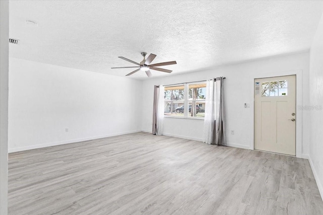 entryway with ceiling fan, light hardwood / wood-style floors, and a textured ceiling