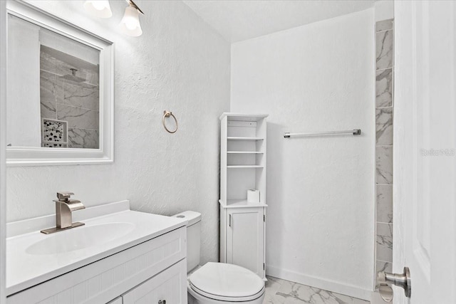 bathroom featuring vanity, toilet, and walk in shower