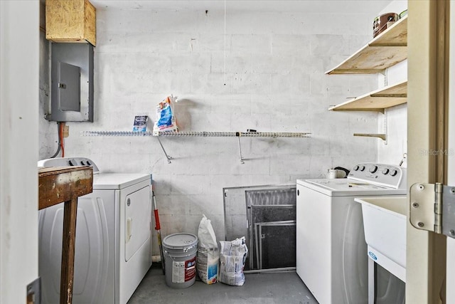 laundry room with electric panel, sink, and washer and dryer