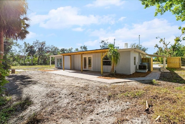 back of house with french doors and cooling unit