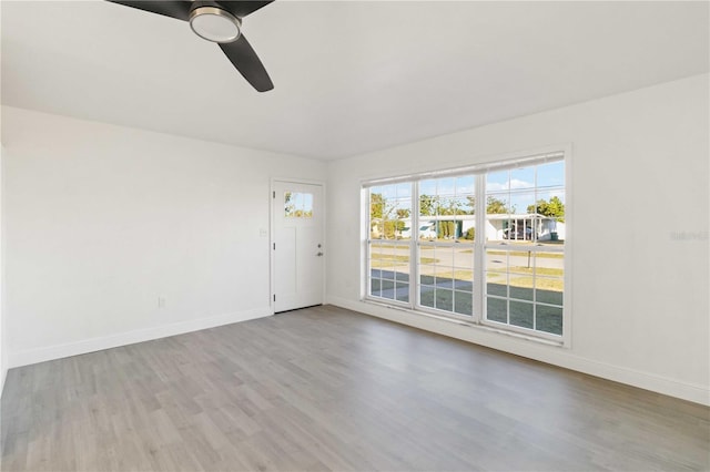 empty room with light hardwood / wood-style floors and ceiling fan