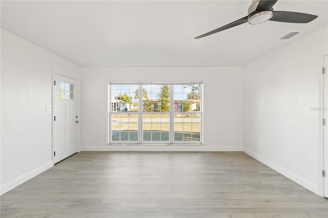 empty room featuring ceiling fan and light wood-type flooring