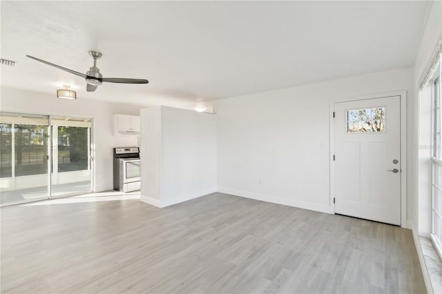 unfurnished living room featuring ceiling fan and light wood-type flooring