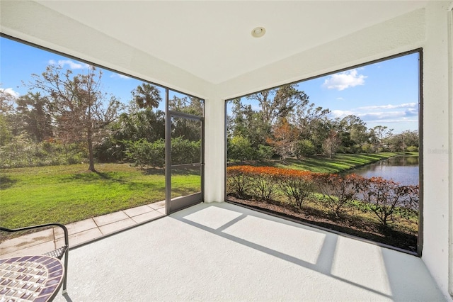 unfurnished sunroom with a water view