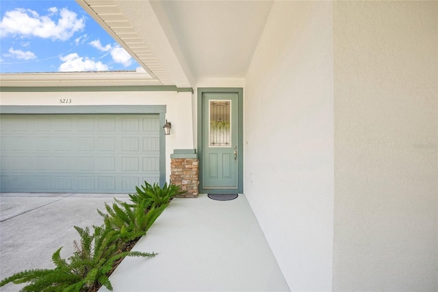 doorway to property featuring a garage