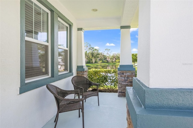 balcony with a porch and a water view