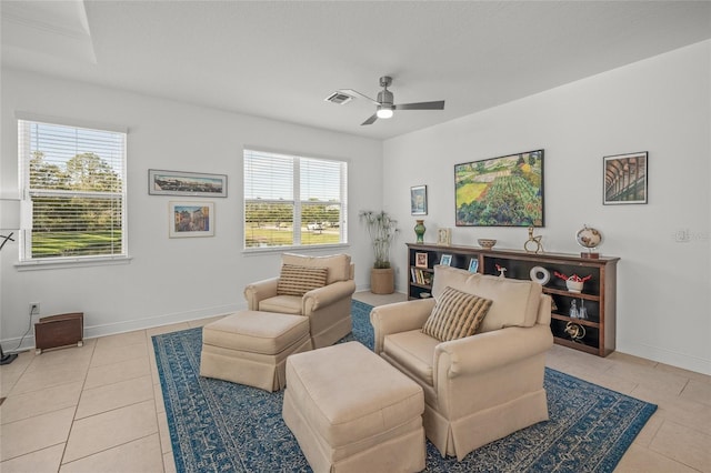 tiled living room featuring ceiling fan and a healthy amount of sunlight